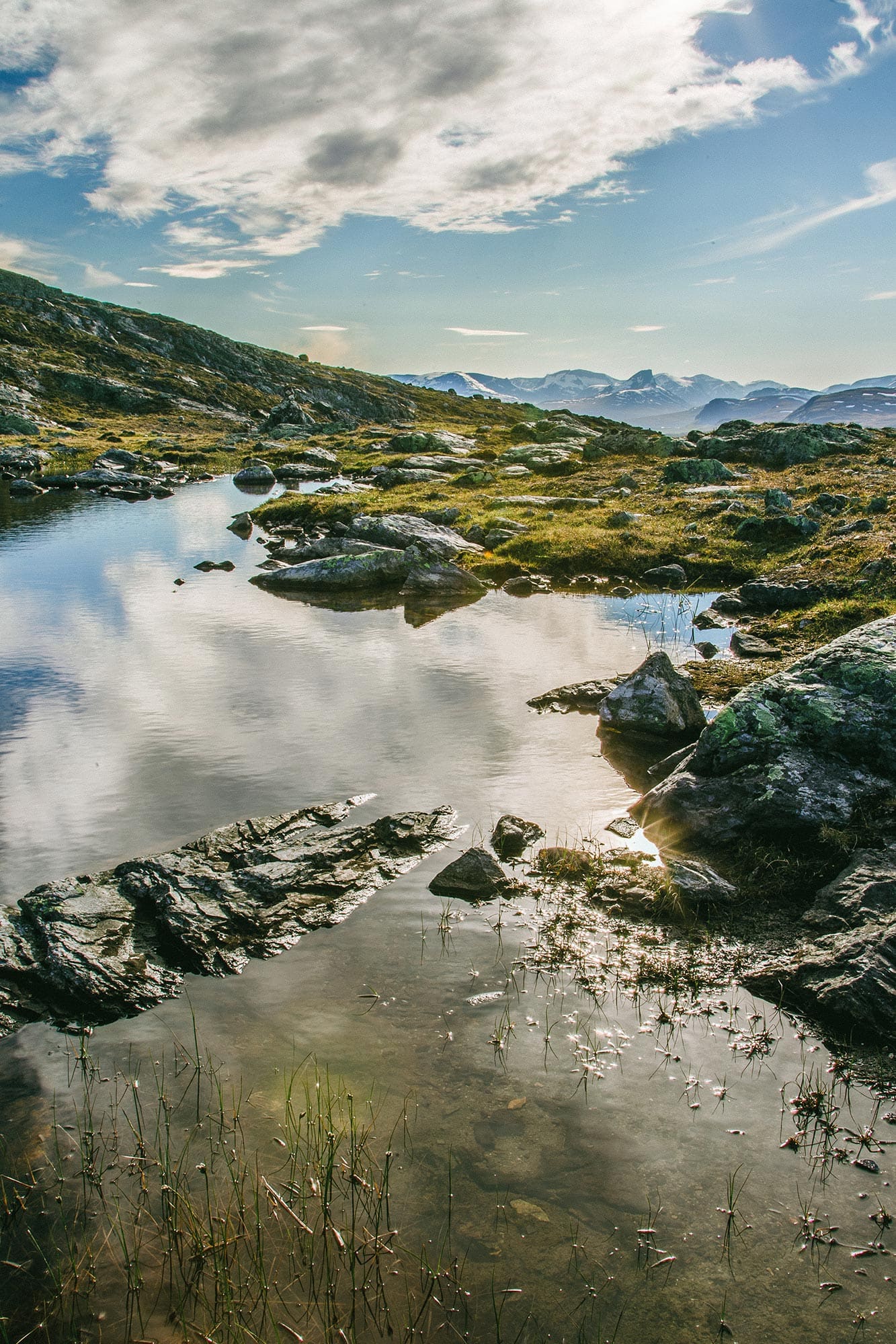 Mountains and clouds reflected in still water, Kilpisjärvi, Finland